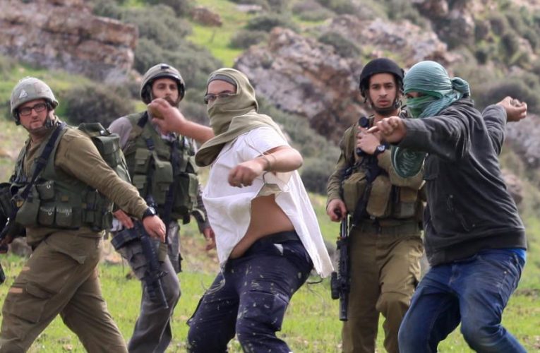 Settlers Invade Islamic Cemetery, Attack Palestinians in Hebron